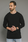 Man wearing a black long-sleeve cotton shirt against a gray background