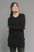 Woman wearing a black long-sleeve cotton shirt dress against a gray background