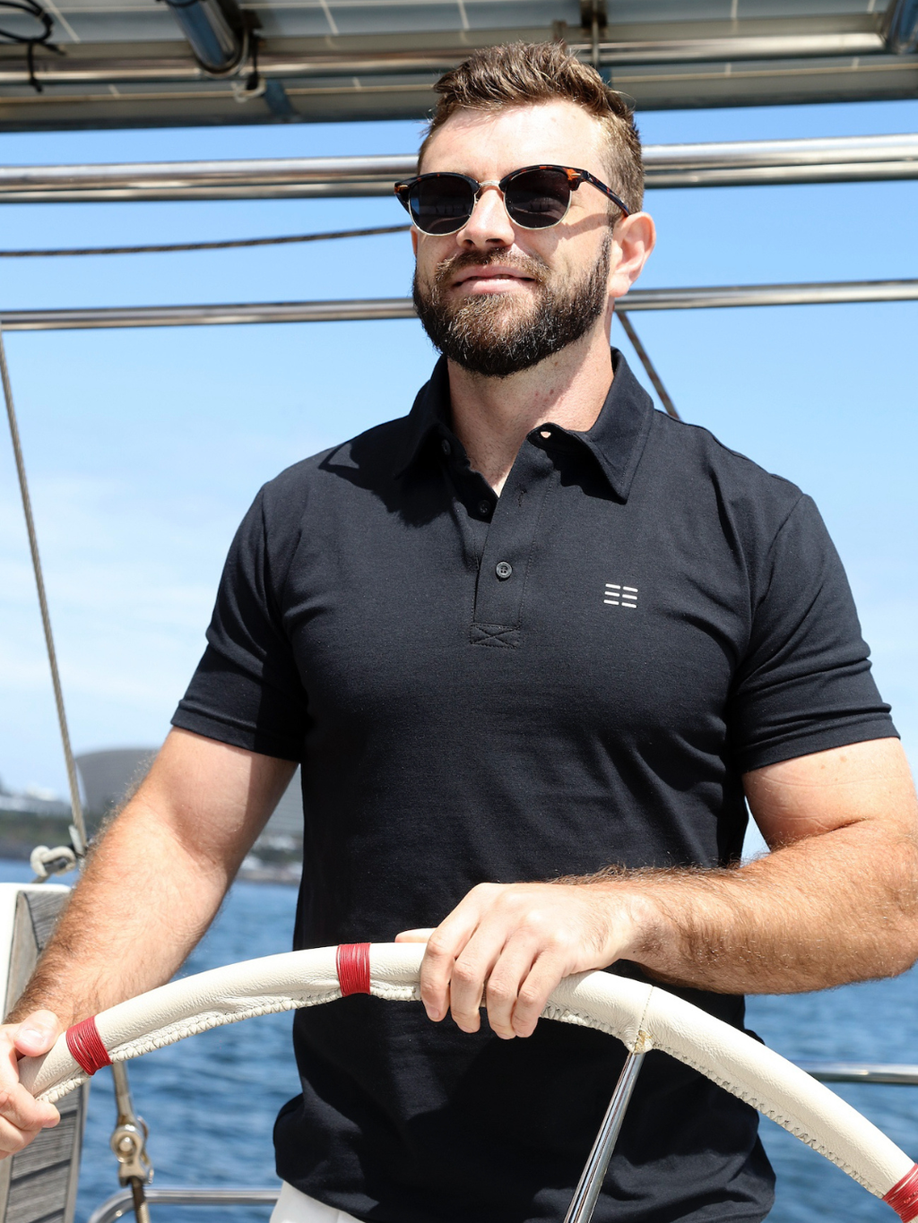 Man wearing sunglasses and a breathable black cotton polo shirt made from Oeko-Tex fabric in Cape Town South Africa by BREETH